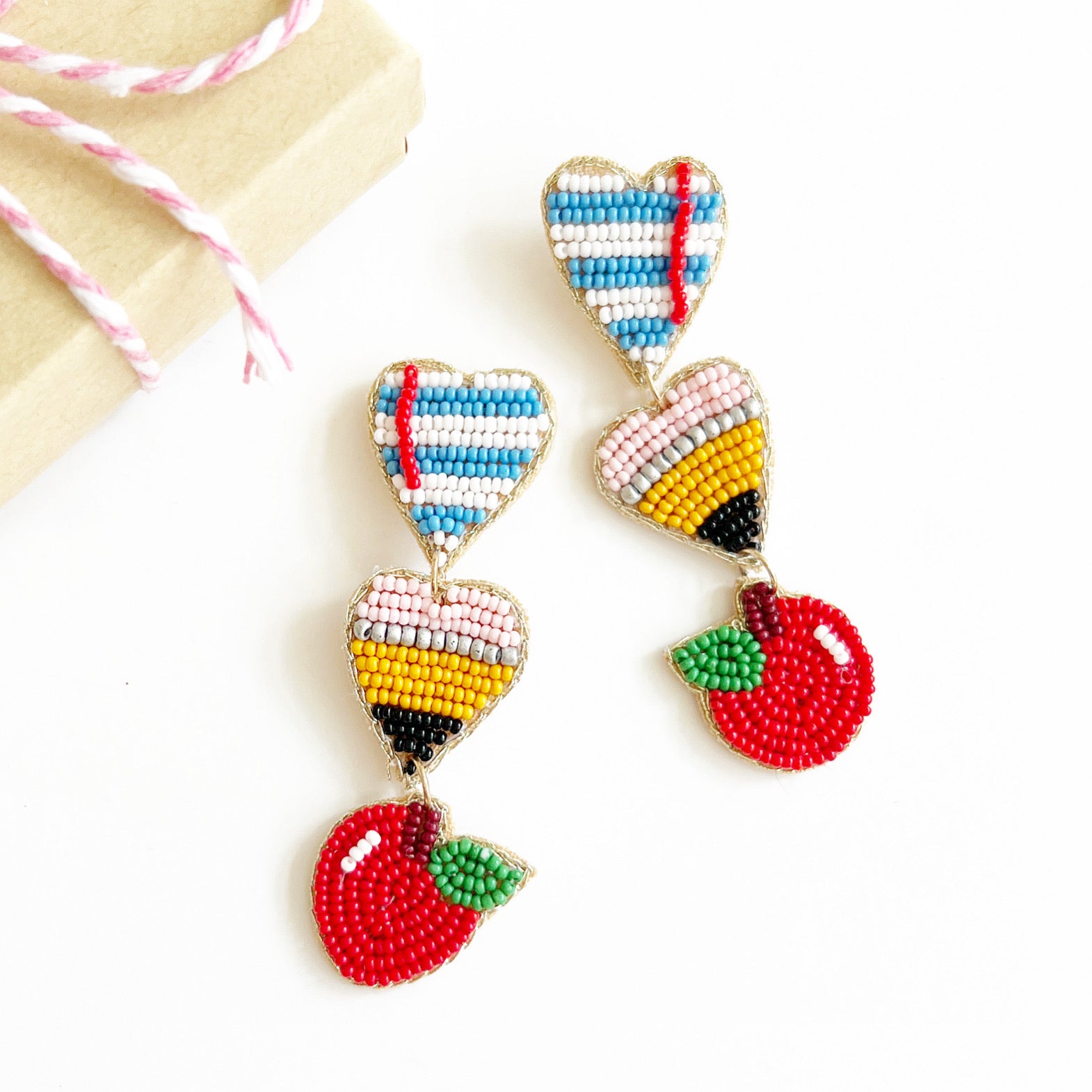 hand beaded school teacher earrings that feature  paper, pencil and apple