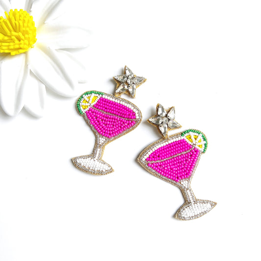 pink cocktail beaded earrings with lime on side of glass