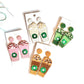 hand beaded coffee earrings laying flat in pink, green, white and orange