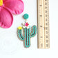 floral cactus beaded earrings on flat surface next to ruler showing they are 3 inches long