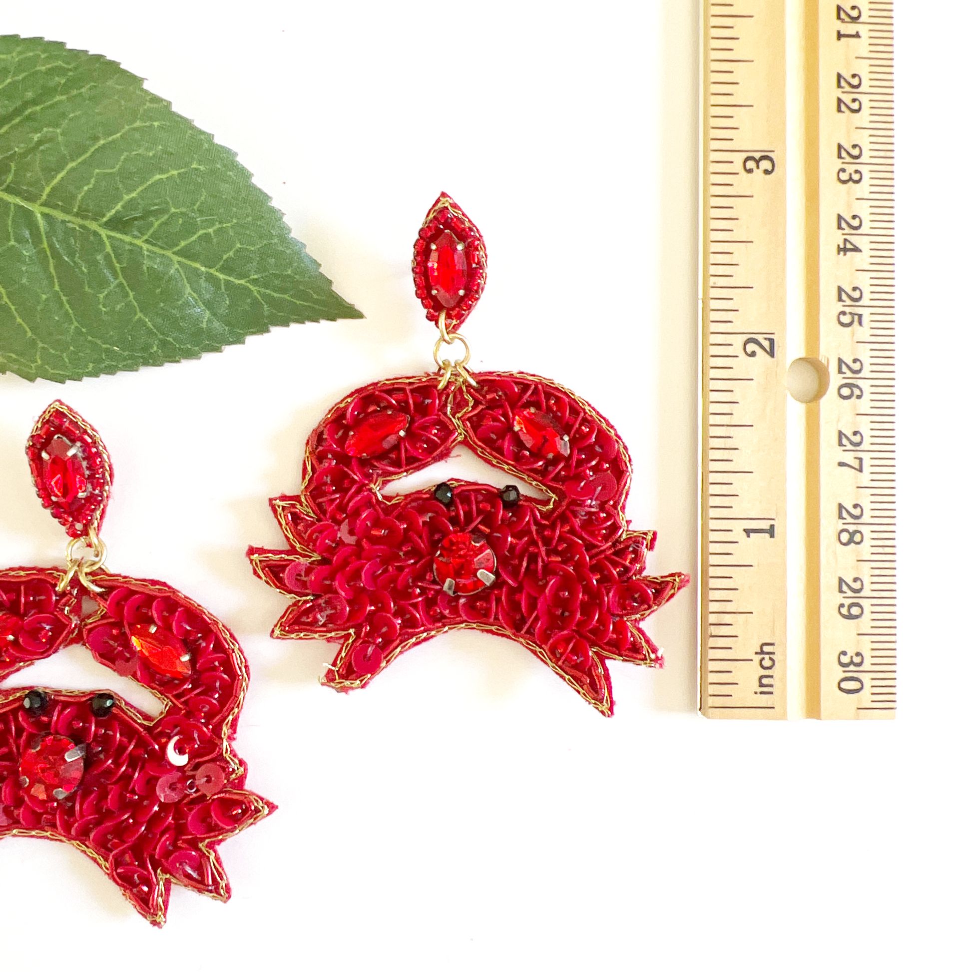 red crab beaded earrings next to ruler showing almost 3 inches in legnth